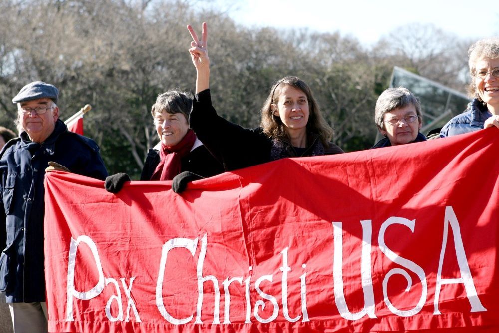 Jean Stoken, a Washington-area resident, flashes a peace sign as members of Pax Christi gather for an anti-war rally on the National Mall in Washington Jan. 27, 2009, calling for an end to the war in Iraq.