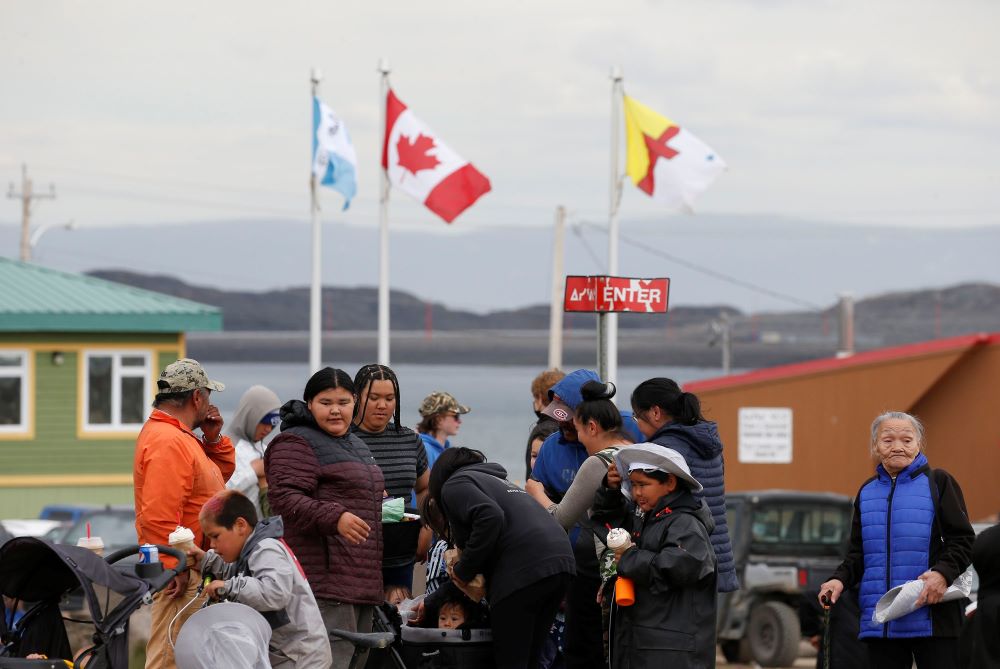 People wait for the start of Pope Francis' meeting with young people and elders outside the primary school in Iqaluit, Nunavut, July 29, 2022. (CNS photo/Paul Haring)
