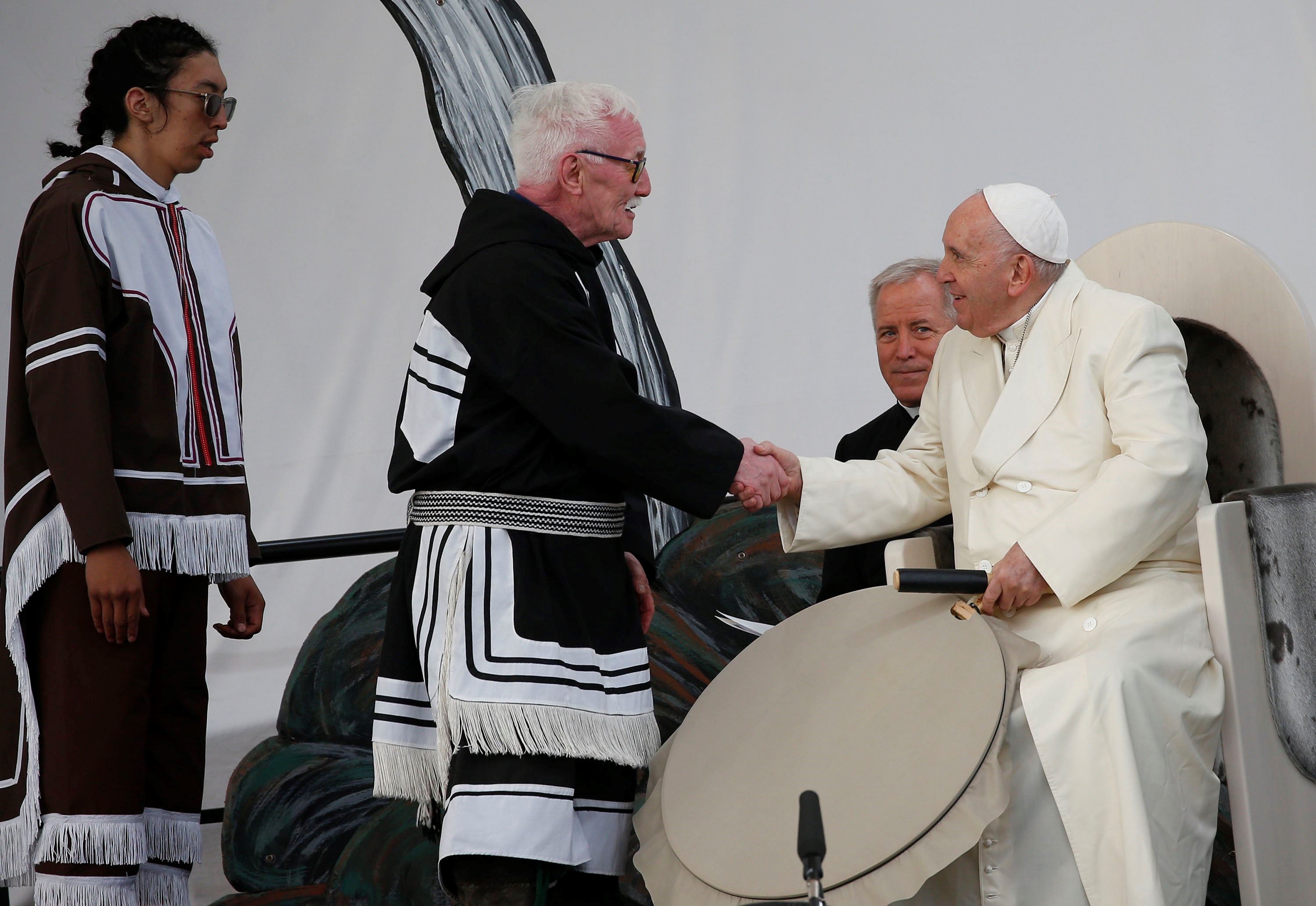 Elder Piita Irniq and youth drum dancer Malachai Angulalik Mala present Pope Francis with a traditional drum during a meeting with young people and elders outside the primary school in Iqaluit in the Canadian territory of Iqaluit, Nunavut, July 29.