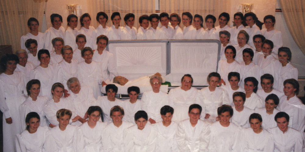 The wives of Rulon Jeffs attend his funeral in this photo featured in the documentary "Keep Sweet: Pray and Obey" on Netflix. He had the words "Keep sweet" affixed to the soles of his shoes. (Courtesy of Netflix © 2022) 