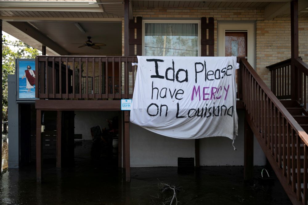 A blanket hangs outside a house in Jean Lafitte, La., Sept. 2 following Hurricane Ida's landfall. (CNS/Reuters/Marco Bello)