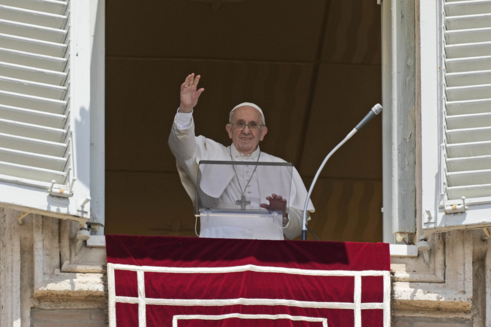 Pope Francis salutes the crowd as he arrives for the Angelus noon prayer from the window of his studio overlooking St.Peter's Square, at the Vatican July 18. (AP/Alessandra Tarantino)