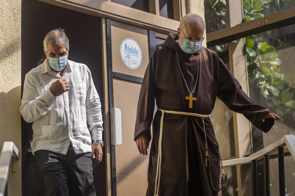 Boston Cardinal Sean O'Malley, right, walks with Eduardo Martínez Díaz, president of BioCubaFarma, as they walk Sept. 9 through Cuba's Genetic Engineering and Biotechnology Center. (AP/Ramon Espinosa)