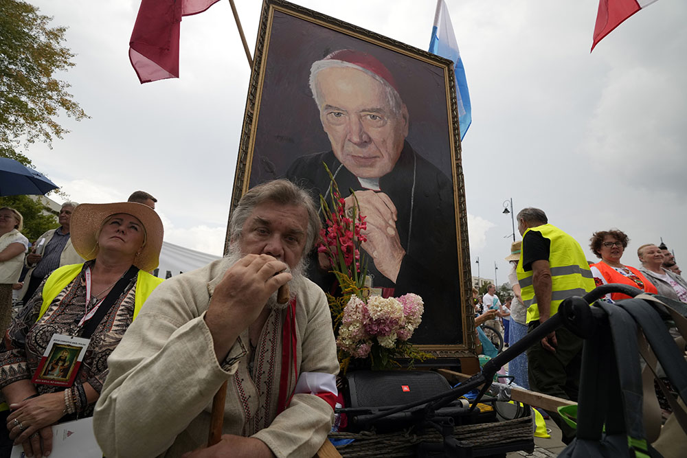 Catholic faithful attend the beatification ceremony of Polish Cardinal Stefan Wyszynski and Mother Elzbieta Roza Czacka in front of the church of Providence in Warsaw, Poland, Sunday, Sept. 12, 2021. (AP/Czarek Sokolowski)