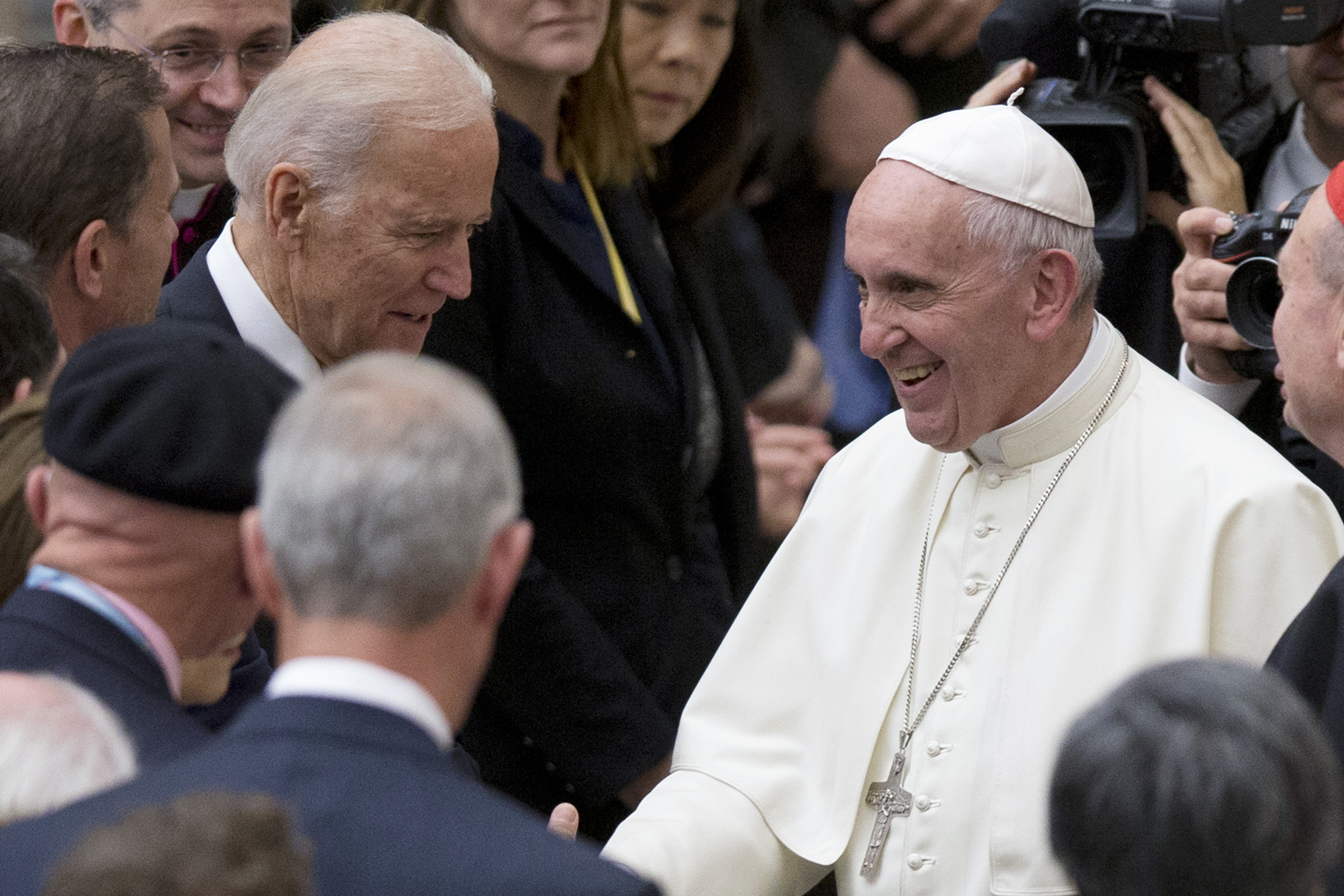 In this April 29, 2016, file photo Pope Francis shakes hands with Vice President Joe Biden as he takes part in a congress on the progress of regenerative medicine and its cultural impact, being held in the Pope Paul VI hall at the Vatican. (AP Photo/Andre