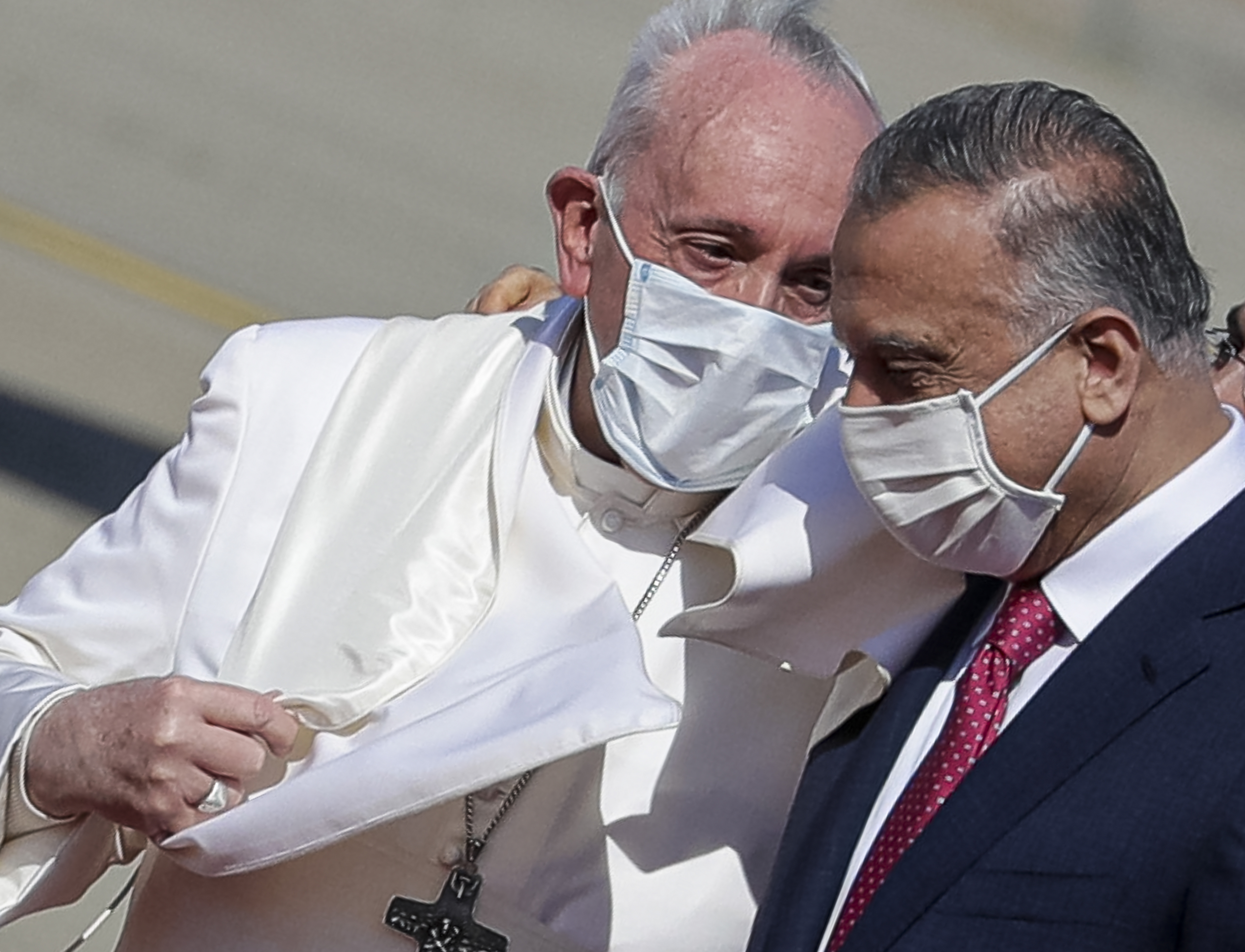 Pope Francis is greeted by Iraqi Prime Minister Mustafa al-Kadhimi as he arrives at Baghdad's international airport, Iraq, on March 5, 2021. (AP Photo/Andrew Medichini)
