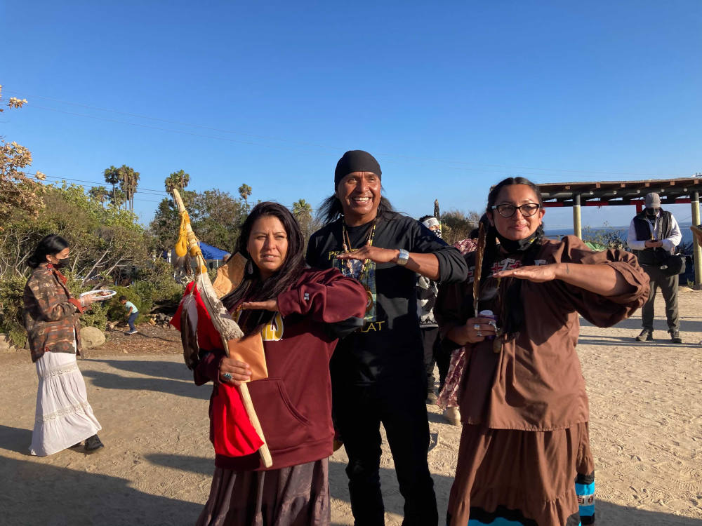 Wendsler Nosie Sr., center, with his daughters at Wishtoyo Chumash Village in Malibu, California, Sunday, Oct. 17, 2021. (RNS photo/Alejandra Molina)