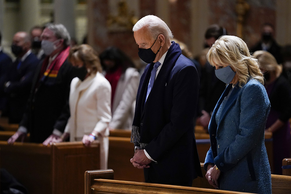On Jan. 20, then-President-elect Joe Biden and his wife, Jill Biden, attend Mass at the Cathedral of St. Matthew the Apostle during Inauguration Day ceremonies in Washington. (AP Photo/Evan Vucci)