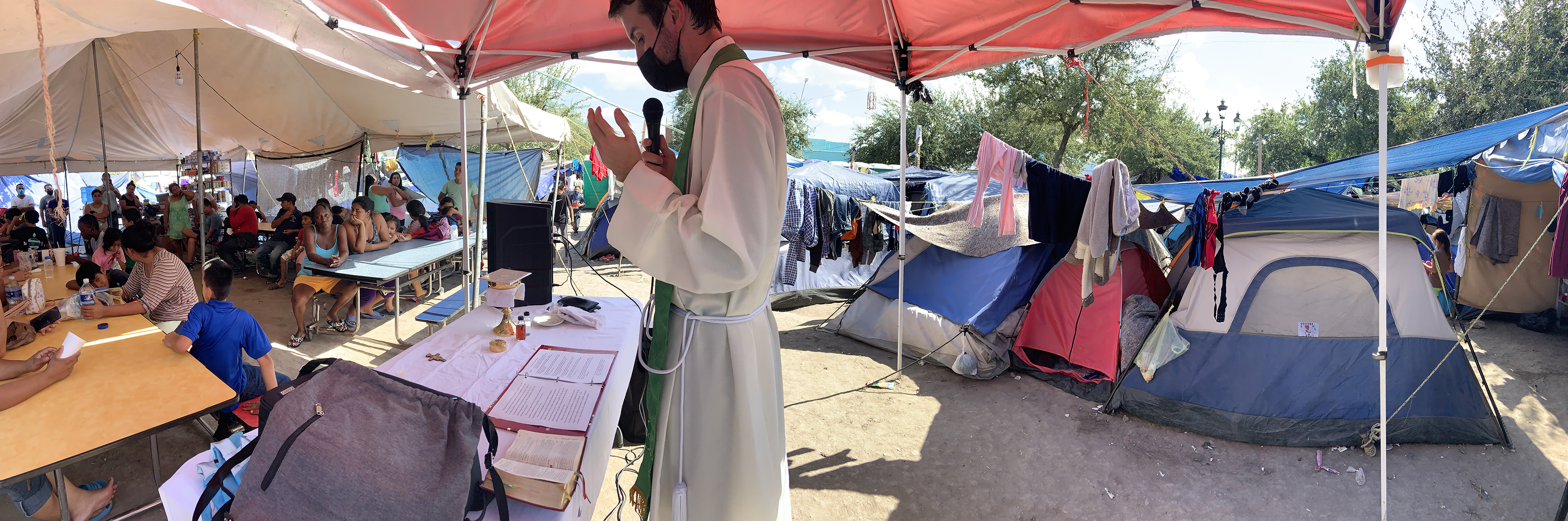 A panoramic view of the Rev. Louie Hotop leading Mass for at a migrant camp in Reynosa, Mexico. (RNS/Courtesy photo)
