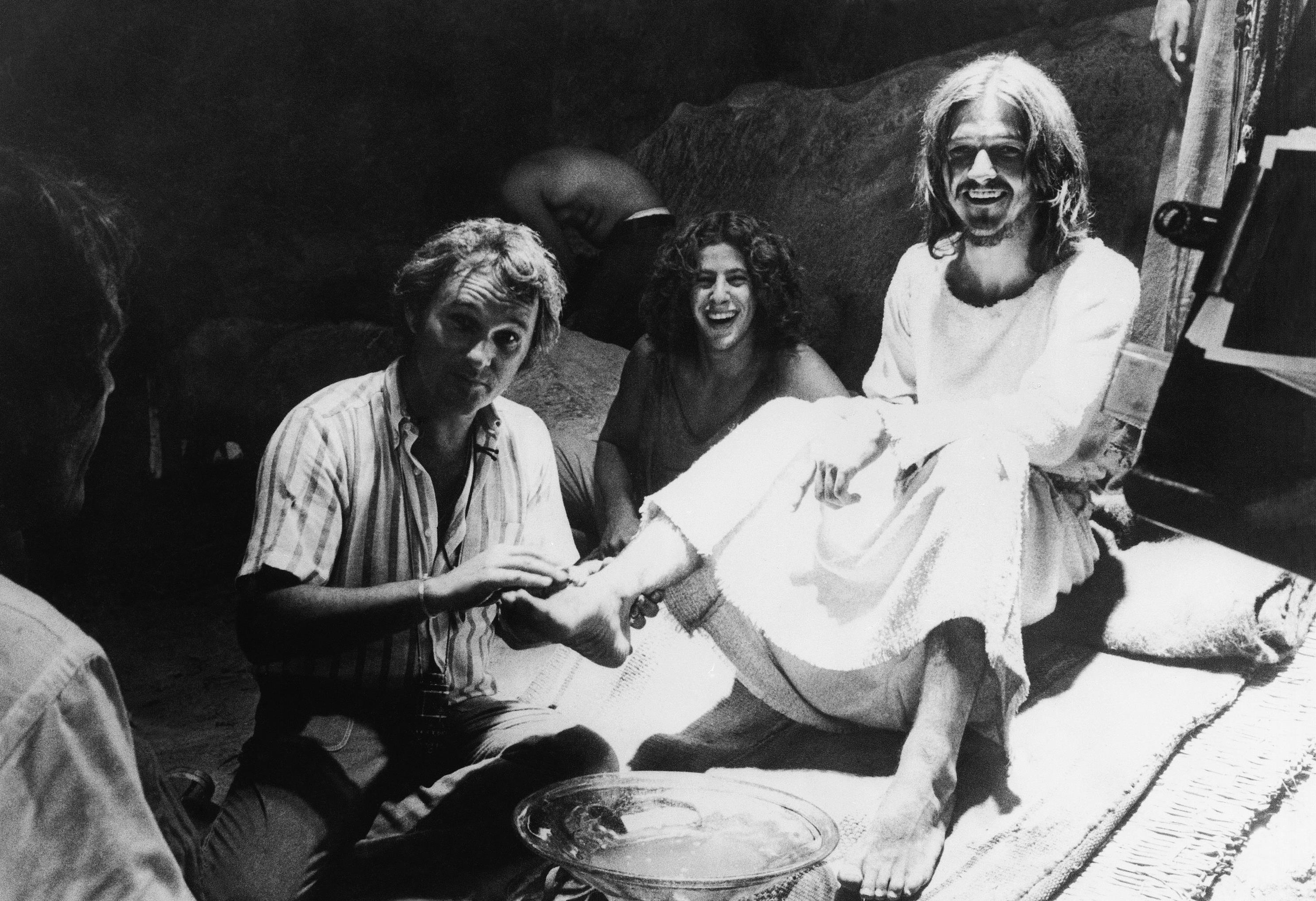 In this Oct. 8, 1972 file photo, producer-director Norman Jewison, left, demonstrates how he wants an actor to wash the feet of Jesus, portrayed by Ted Neeley, during filming of the movie version of the Rock Musical, "Jesus Christ Superstar," in Bethlehem