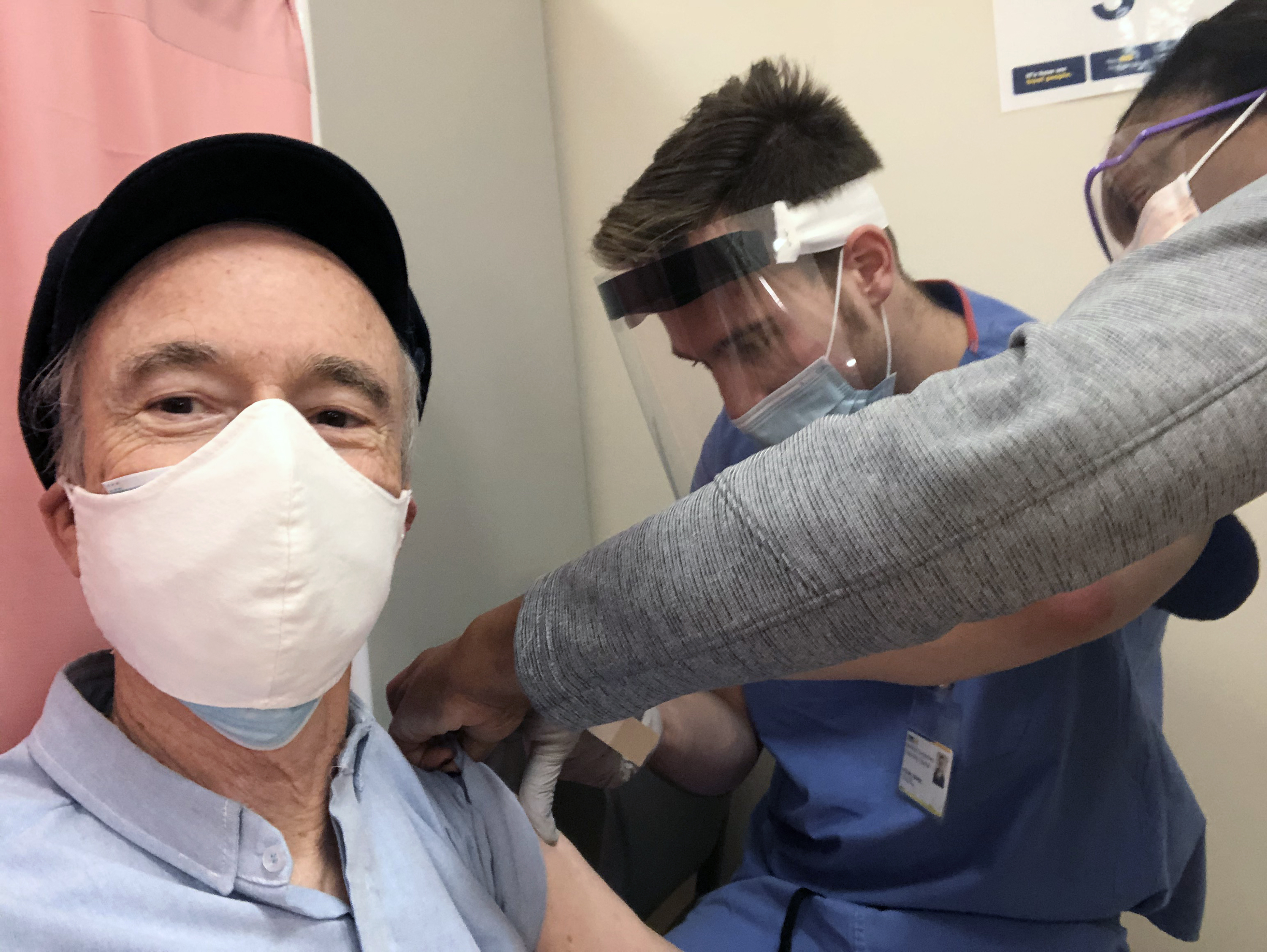 The Rev. Tom Reese, left, receives a COVID-19 vaccine from Dr. Michael Markel, center, and nurse Dia Hannah at Georgetown University Hospital, Medstar Health, Thursday, January 21, 2021. (RNS photo by Tom Reese)