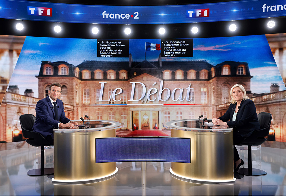 Centrist candidate and French President Emmanuel Macron, left, and far-right contender Marine Le Pen pose before a televised debate April 20 in La Plaine-Saint-Denis, outside Paris. (Ludovic Marin, Pool via AP) Centrist candidate and French President Emmanuel Macron, left, and far-right contender Marine Le Pen pose before a televised debate April 20 in La Plaine-Saint-Denis, outside Paris. (Ludovic Marin, Pool via AP)