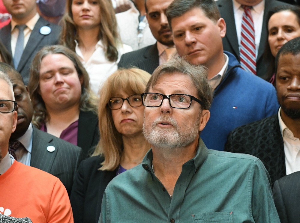 Brian Toale speaks while standing with New York legislators, survivors and advocates in favor of the Child Victims Act at the state Capitol in Albany Jan. 28. (AP Photo/Hans Pennink)