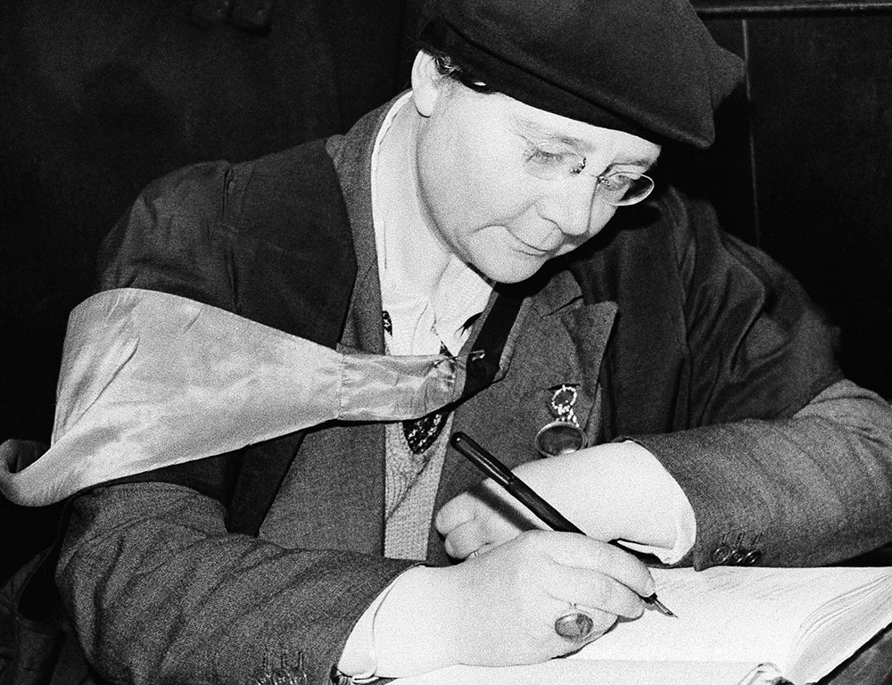 Dorothy L. Sayers signs a visitors' book Feb. 6, 1942, at St. Martin-in-the-Fields church in London, where she addressed the congregation at a lunchtime service. (AP Photo)
