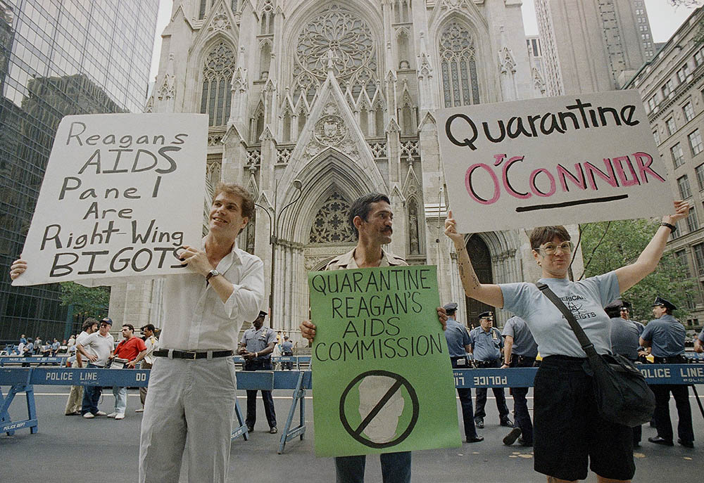 Demonstrators hold signs in front of St. Patrick's Cathedral in New York City on Aug. 2, 1987, to protest the appointment of Cardinal John O'Connor to a national AIDS panel, which gay rights activists said was "stacked" against them. (AP/Mario Cabrera)