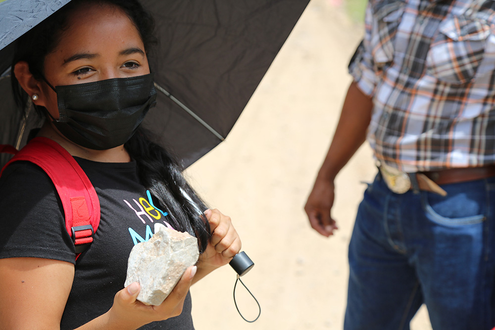 Yorito resident Aura Murillo Torres, 35, holds up a rock as she recalls how two years earlier town residents banded together, armed with stones like the one she holds, to fight off a mining company and its contingent of armed security.