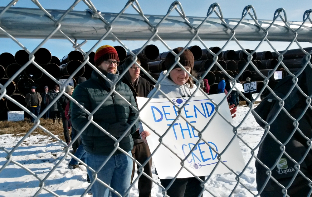 Brenna Cussen Anglada of St. Isidore Catholic Worker Farm heads a line of protesters risking arrest at a pipeline storage yard in Carlton County, Minnesota, April 9. (NCR photo/Maria Benevento)