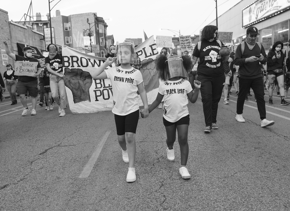 People march down a street at the "Together We Rise Black & Brown Rally" in Chicago, June 8 (Courtesy of Mateo Zapata) People march down a street at the "Together We Rise Black & Brown Rally" in Chicago, June 8 (Courtesy of Mateo Zapata)