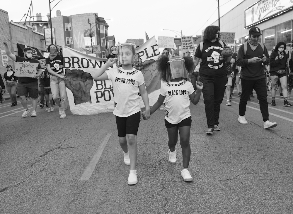 People march down a street at the "Together We Rise Black & Brown Rally" in Chicago, June 8 (Courtesy of Mateo Zapata)