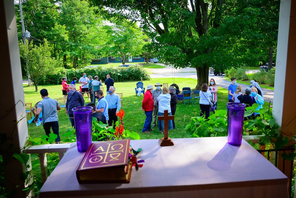 People spend time in conversation following the outdoor Mass at the home of Larry and Diane Kahlscheuer on Washington Island, Wisconsin, Sept. 6. (CNS/The Compass/Sam Lucero)