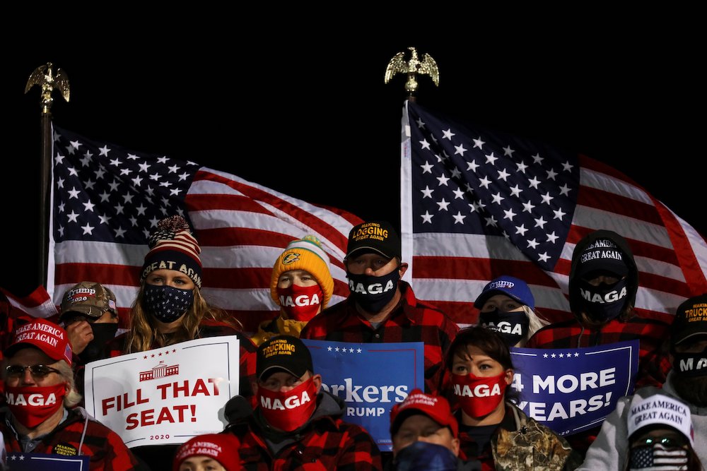 Supporters of President Donald Trump hold signs and wear face masks during a campaign rally at Duluth International Airport in Duluth, Minnesota, Sept. 30. (CNS/Reuters/Leah Millis)