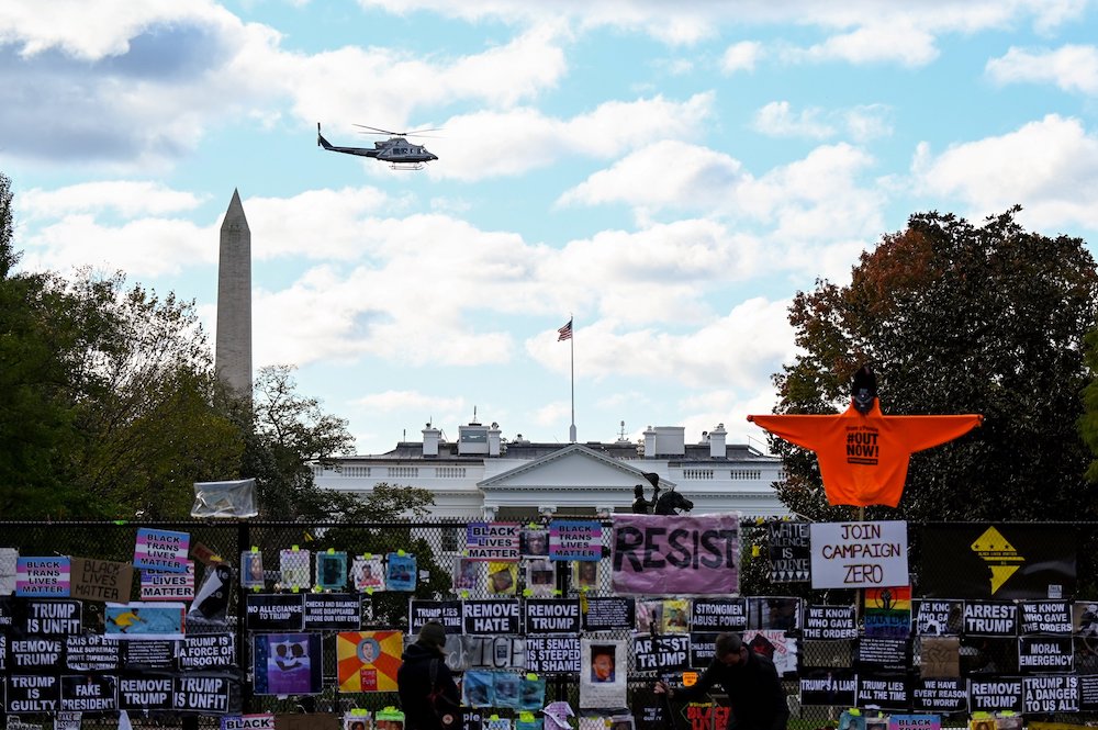 A helicopter passes over the White House in Washington Nov. 2, the day before the U.S. presidential election. (CNS/Reuters/Erin Scott)