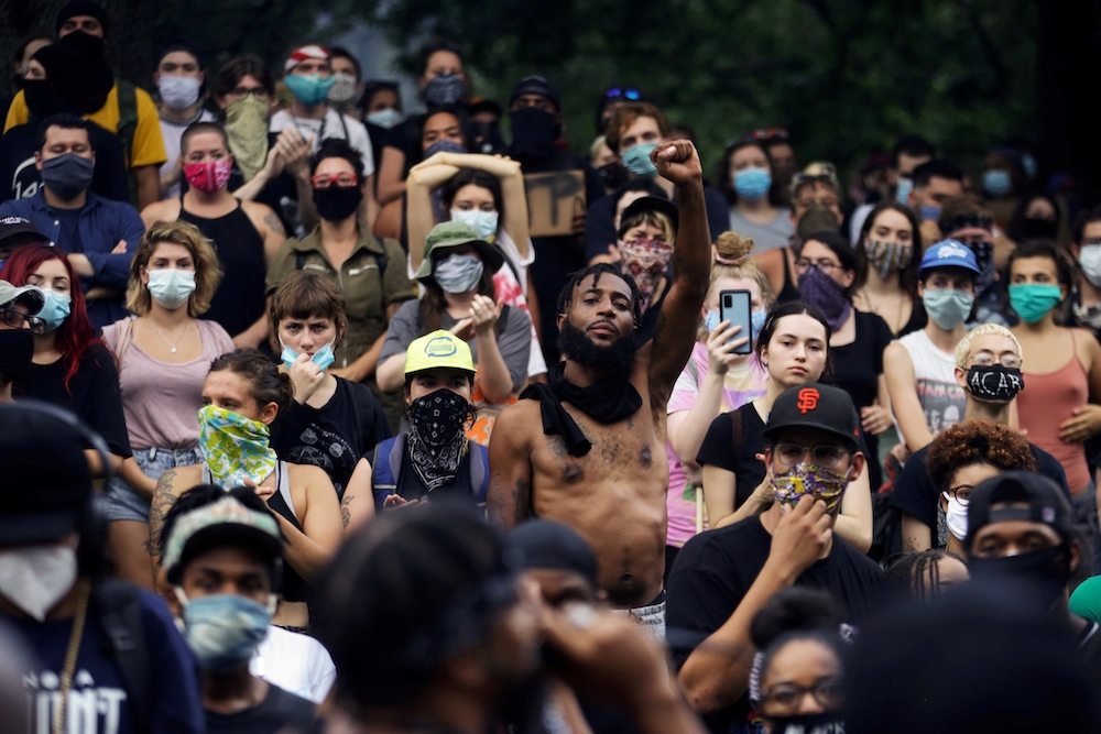 Protesters in New Orleans gather May 30, mostly wearing masks, in response to the May 25 police killing of George Floyd in Minneapolis. This was during the New Orleans' Phase One of reopening: "Restrictions on some low-risk operations will be eased," whic