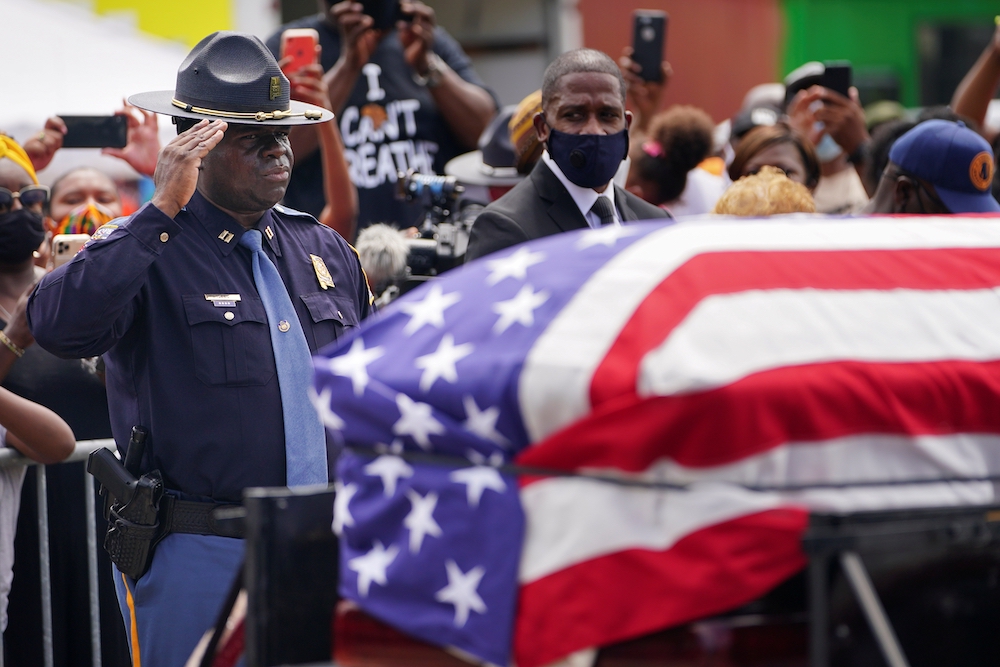 An Alabama State Trooper salutes the casket carrying the late Rep. John Lewis, D-Ga., after it was carried across the Edmund Pettus Bridge in a horse-drawn carriage in Selma, Alabama, July 26. The civil rights movement legend who was a colleague of the Re An Alabama State Trooper salutes the casket carrying the late Rep. John Lewis, D-Ga., after it was carried across the Edmund Pettus Bridge in a horse-drawn carriage in Selma, Alabama, July 26. The civil rights movement legend who was a colleague of the Re
