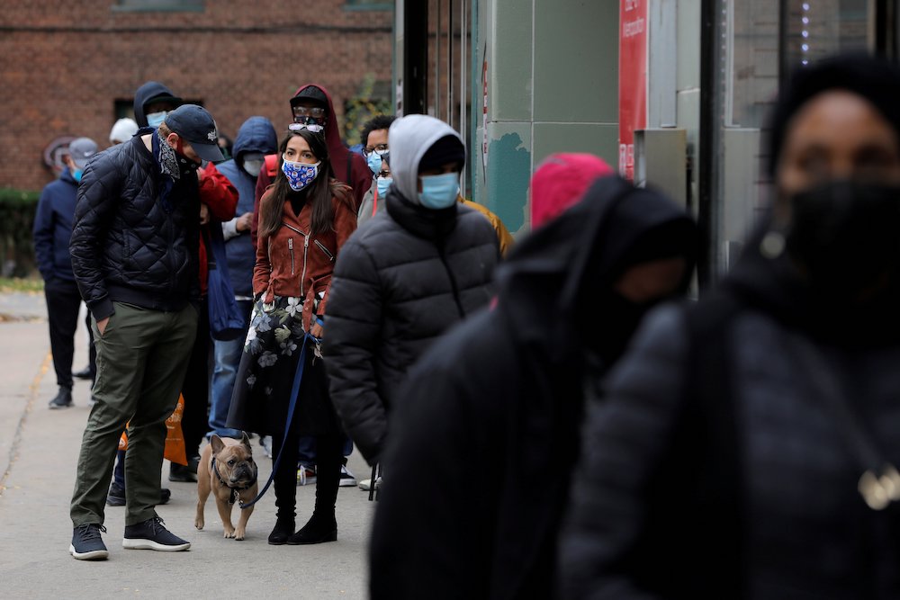U.S. Rep. Alexandria Ocasio-Cortez, glasses on head, stands in line to vote in the Bronx borough of New York City Oct. 25. (CNS/Reuters/Andrew Kelly) U.S. Rep. Alexandria Ocasio-Cortez, glasses on head, stands in line to vote in the Bronx borough of New York City Oct. 25. (CNS/Reuters/Andrew Kelly)