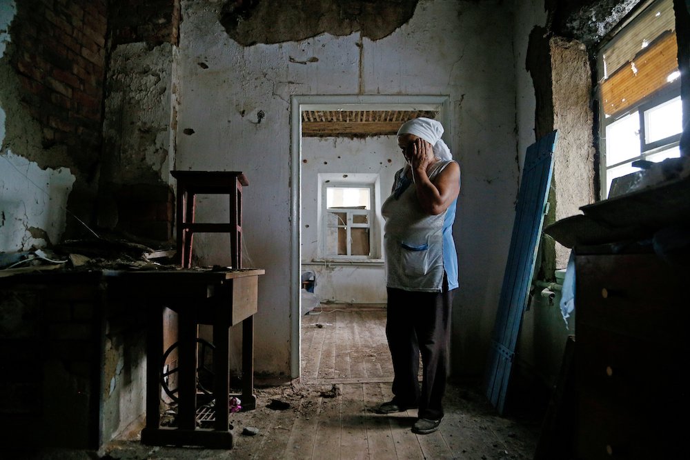 Katerina Izvekova, 77, inside her home damaged during a military conflict between militants of the self-proclaimed Donetsk People's Republic and the Ukrainian armed forces in late July (CNS/Reuters/Alexander Ermochenko) Katerina Izvekova, 77, inside her home damaged during a military conflict between militants of the self-proclaimed Donetsk People's Republic and the Ukrainian armed forces in late July (CNS/Reuters/Alexander Ermochenko)