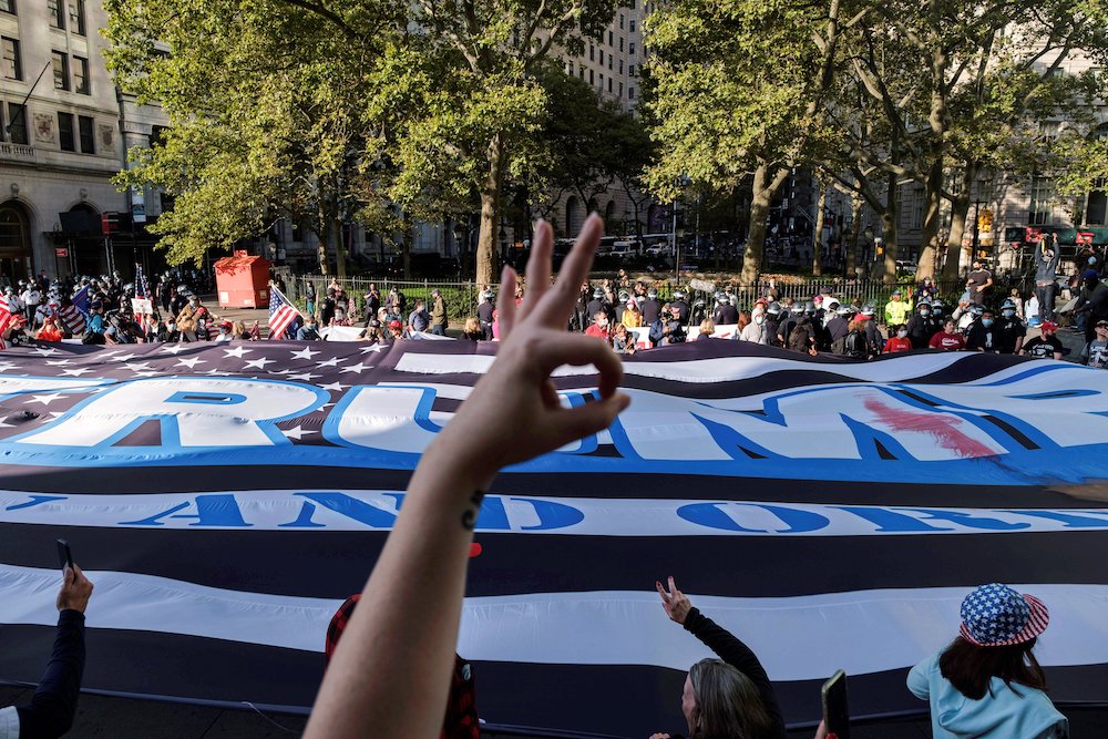 Supporters of President Donald Trump march in New York City Oct. 21. The hand in the foreground is making a gesture used by those on the right and sometimes by extremists or white supremacists. It was added to the Anti-Defamation League's symbols database