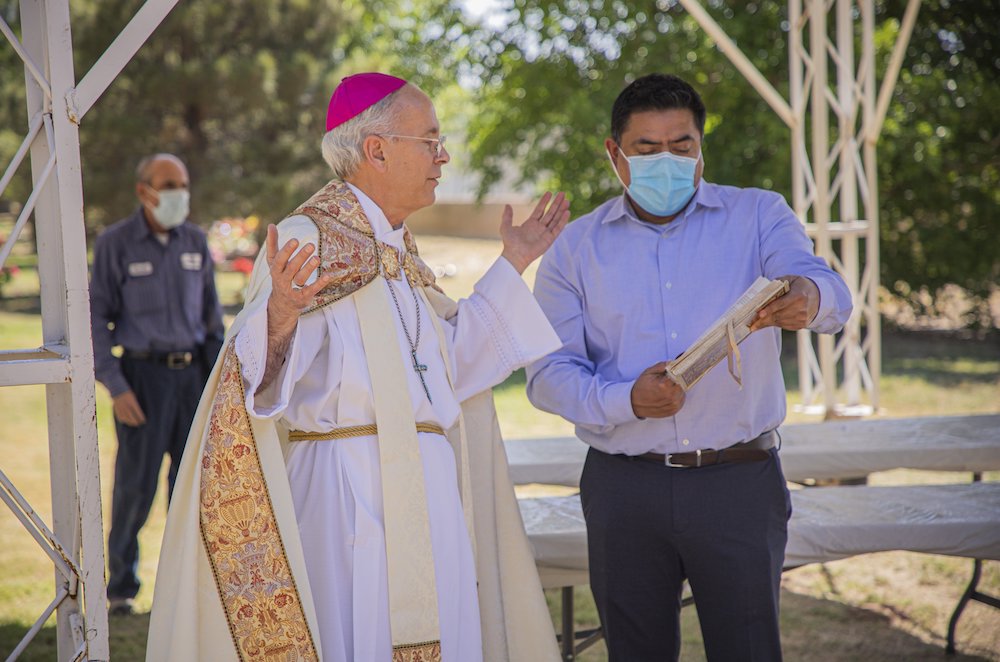Bishop Mark Seitz of El Paso, Texas, takes part in a burial ceremony April 29, at Our Lady of Mount Carmel Cemetery in El Paso, Texas. (CNS/Courtesy of the El Paso Diocese/Fernie Ceniceros)
