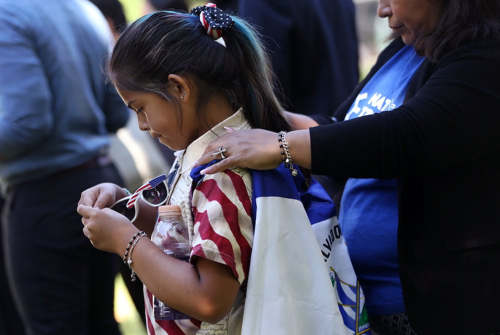 Marilyn Miranda, 9, draped in a Salvadoran flag, attends an immigration rally with her mother outside the U.S. Capitol in Washington June 4, 2019 Marilyn Miranda, 9, draped in a Salvadoran flag, attends an immigration rally with her mother outside the U.S. Capitol in Washington June 4, 2019