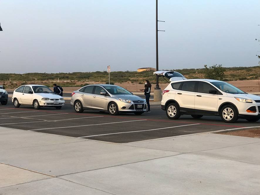 Volunteers from Hope Border Institute in El Paso, Texas, register voters in mid-September as they wait in line in their cars for food distribution. (CNS/Courtesy of Hope Border Institute)