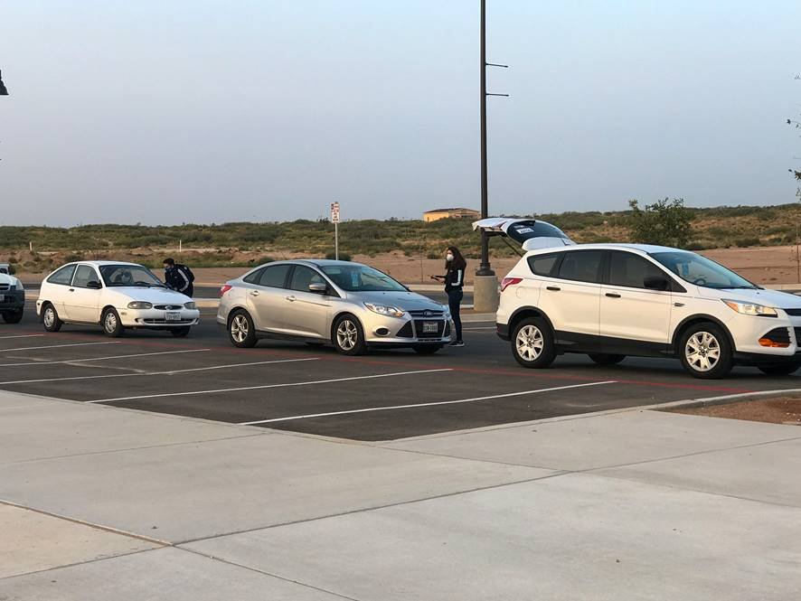 Volunteers from Hope Border Institute in El Paso, Texas, register voters in mid-September as they wait in line in their cars for food distribution. (CNS/Courtesy of Hope Border Institute) Volunteers from Hope Border Institute in El Paso, Texas, register voters in mid-September as they wait in line in their cars for food distribution. (CNS/Courtesy of Hope Border Institute)