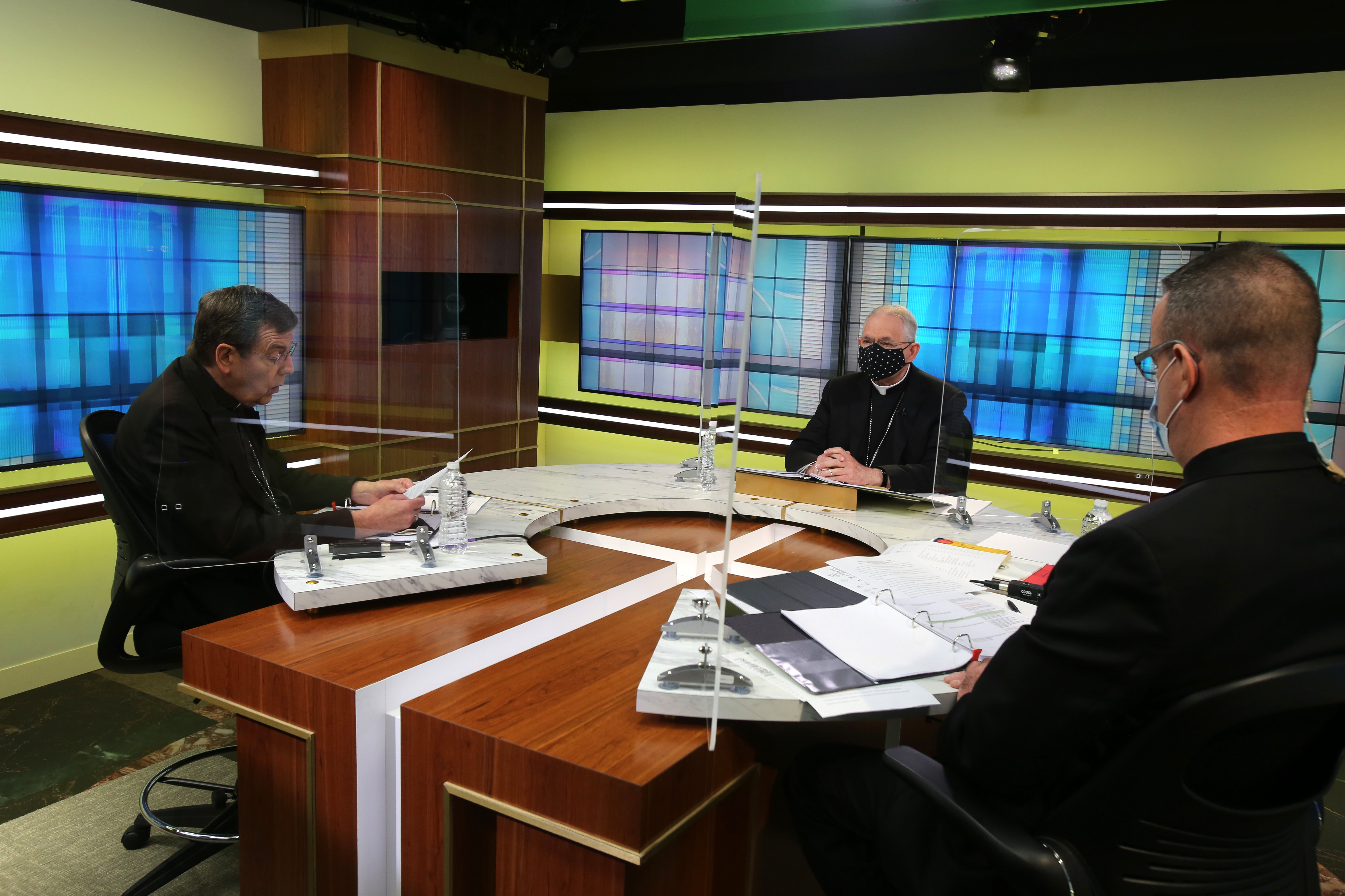 Detroit Archbishop Allen Vigneron, vice president of the U.S. Conference of Catholic Bishops, left, leads the opening prayer Nov. 17 at the conference's headquarters in Washington during the bishops' virtual fall meeting. Also pictured are Archbishop Jose