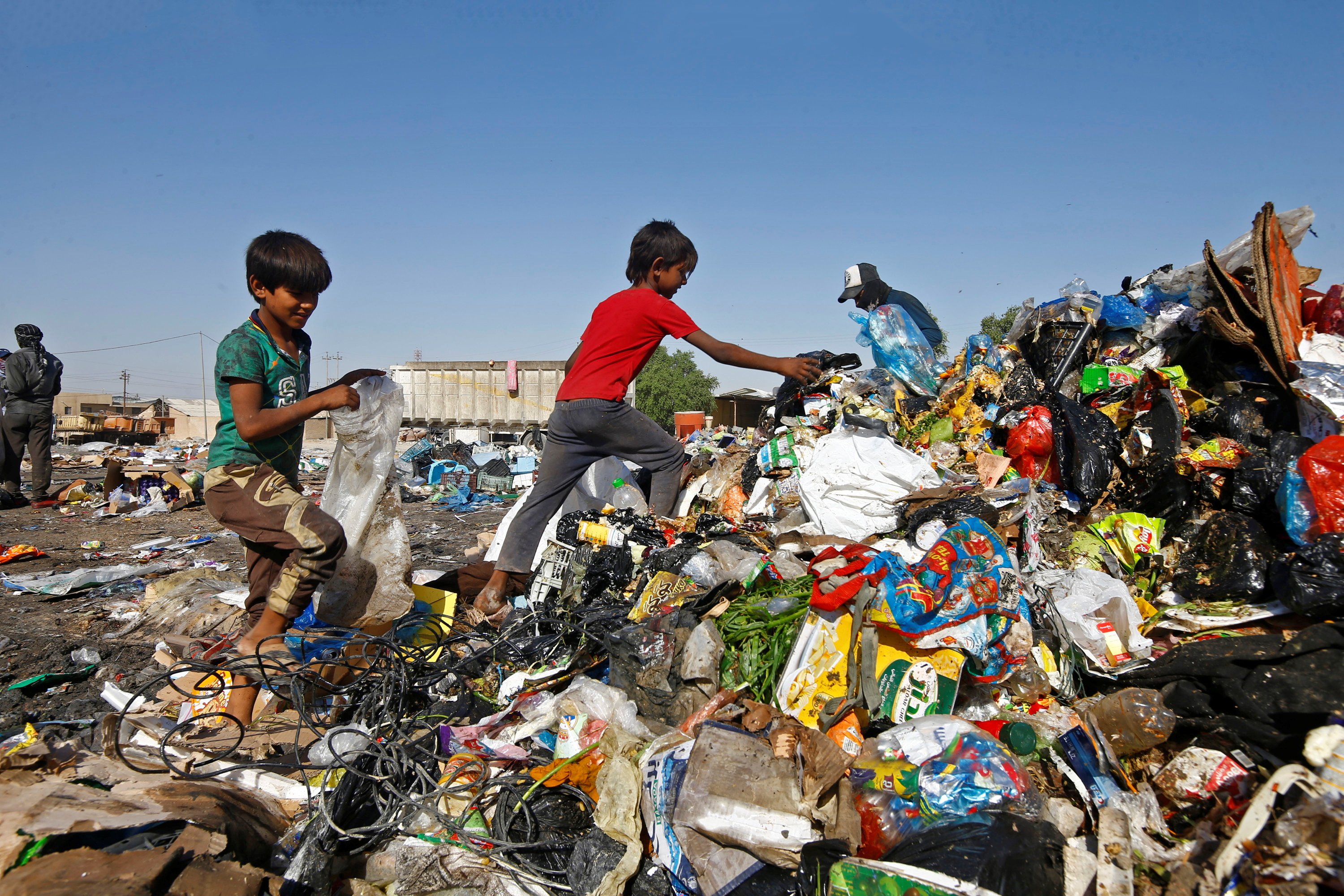 Iraqi children collect recyclable things from a garbage dump in Najaf, Iraq, Oct. 23. (CNS/Alaa Al-Marjani) Iraqi children collect recyclable things from a garbage dump in Najaf, Iraq, Oct. 23. (CNS/Alaa Al-Marjani)