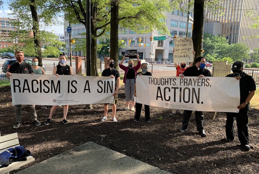Members of Maryland Lutheran churches hold up banners calling for action against racism during an interfaith prayer vigil in Baltimore June 3, 2020, to pray for justice and peace following the May 25 death of George Floyd. (CNS/Catholic Review/Tim Swift)