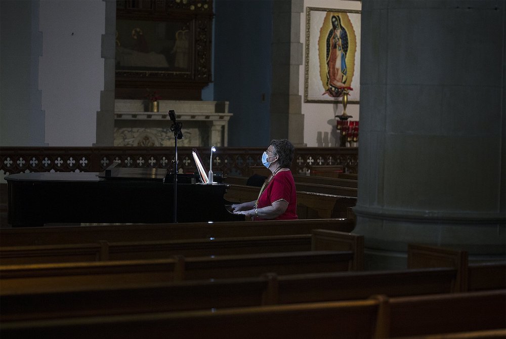 Patricia Burkhardt rehearses prior to Mass at St. Gabriel Catholic Church in Washington July 11. (CNS/Tyler Orsburn)