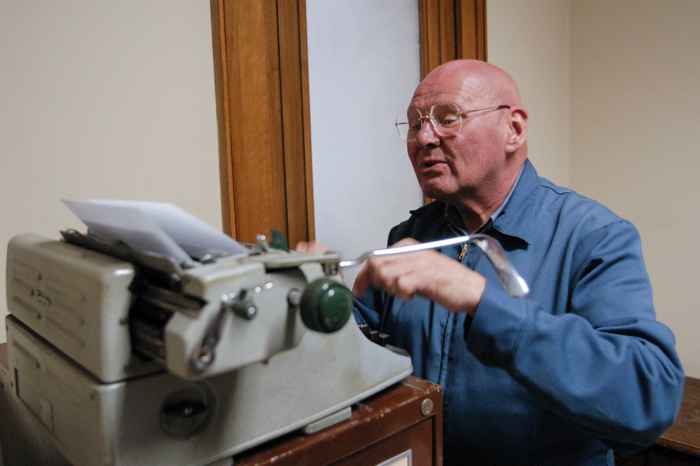 Known for his homework sheets created on a manual typewriter, Discalced Carmelite Fr. Reginald Foster is seen working in his Vatican office in January 2007. He died Dec. 25, 2020, in Milwaukee, Wisconsin, at age 81. (CNS/Chris Warde-Jones)