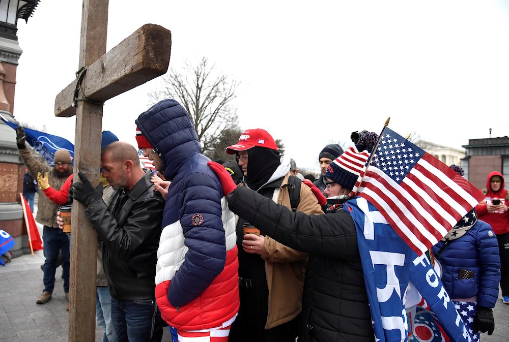 Supporters of President Donald Trump pray outside the U.S. Capitol in Washington Jan. 6, 2021. (CNS/Reuters/