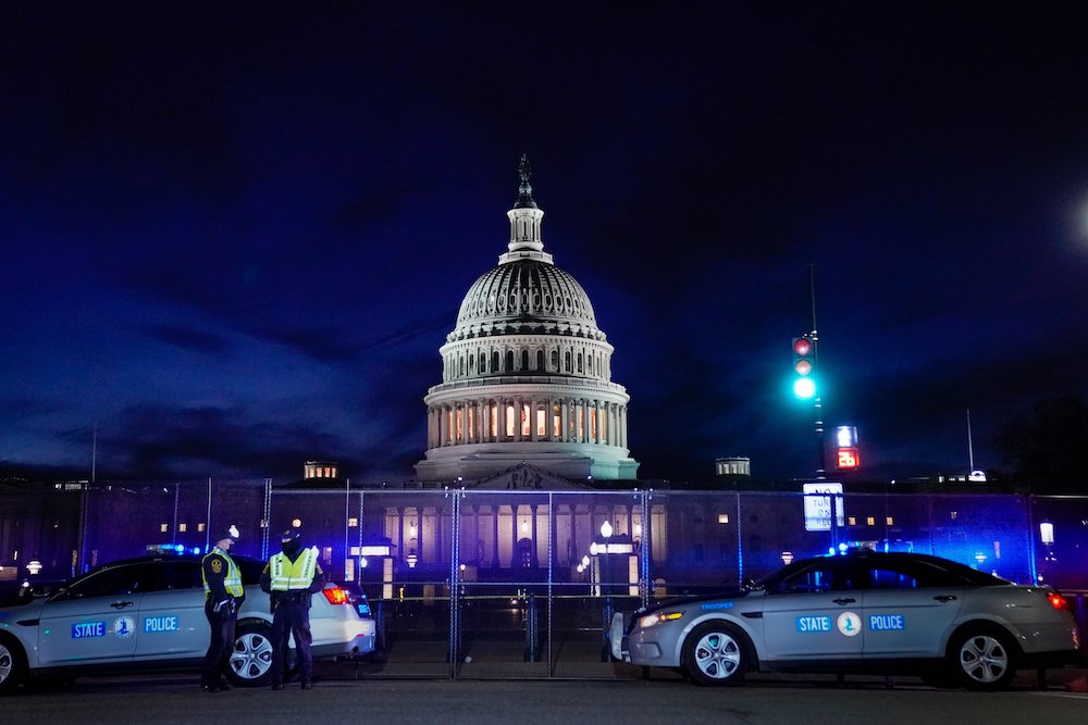 The U.S. Capitol in Washington is seen behind heavy-duty security fencing Jan. 7, 2021, one day after supporters of President Donald Trump stormed Capitol Hill. (CNS/Reuters/Erin Scott)