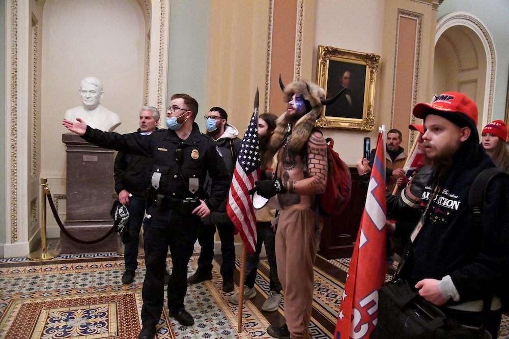 A police officer speaks to supporters of President Donald Trump who got inside the U.S. Capitol Jan. 6, 2021. (CNS/Reuters/Mike Theiler)