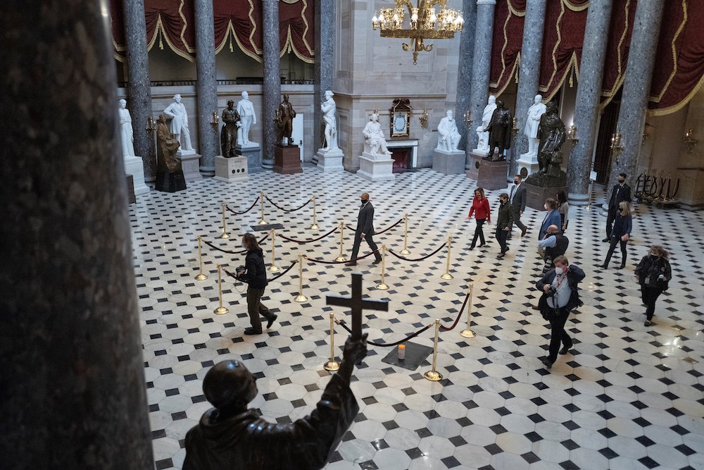 Speaker of the House Nancy Pelosi walks beside staff members and journalists through Statuary Hall of the U.S. Capitol in Washington Jan. 25, 2021. (CNS/Reuters/Tom Brenner)