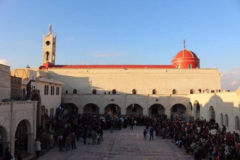 Crowds surround Cardinal Pietro Parolin, Vatican secretary of state, Dec. 28, 2018, as he visits the Syriac Catholic cathedral, St. Mary al-Tahira, in Qaraqosh, a city in the Ninevah Plains, where some 100,000 Christians were uprooted in 2014 by Islamic S