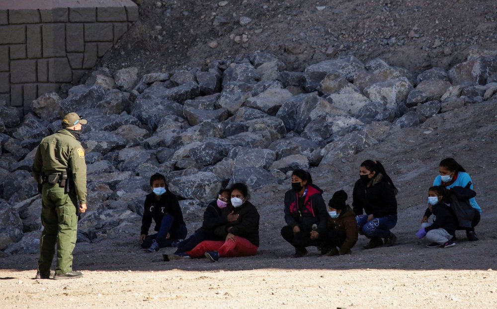 Migrants are detained by a U.S. Border Patrol agent in El Paso, Texas, Feb. 9, 2021, as they turn themselves in to request asylum. (CNS/Reuters/Jose Luis Gonzalez)