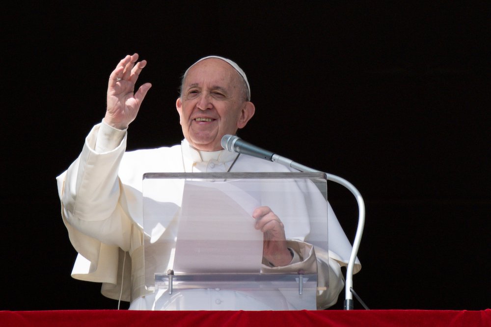 Pope Francis greets the crowd as he leads the Angelus from the window of his studio overlooking St. Peter's Square at the Vatican Feb. 28, 2021. (CNS/Vatican Media)