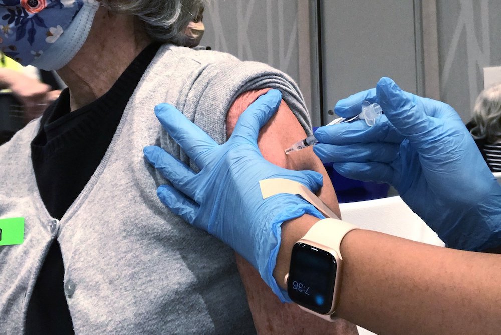 Susan Lavin, a member of The Madeleine Parish in Portland, Oregon, receives a COVID-19 vaccine at the Oregon Convention Center Feb. 24, 2021. (CNS/Catholic Sentinel/Courtesy of Susan Lavin)