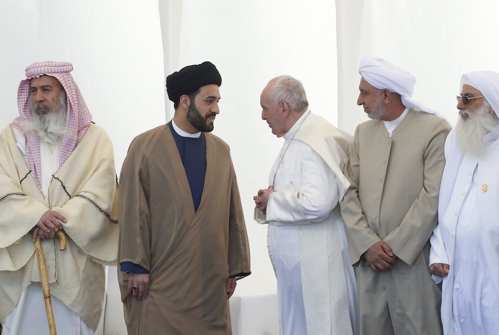 Pope Francis talks with a religious leader during an interreligious meeting on the plain of Ur near Nasiriyah, Iraq, March 6, 2021. (CNS/Paul Haring)