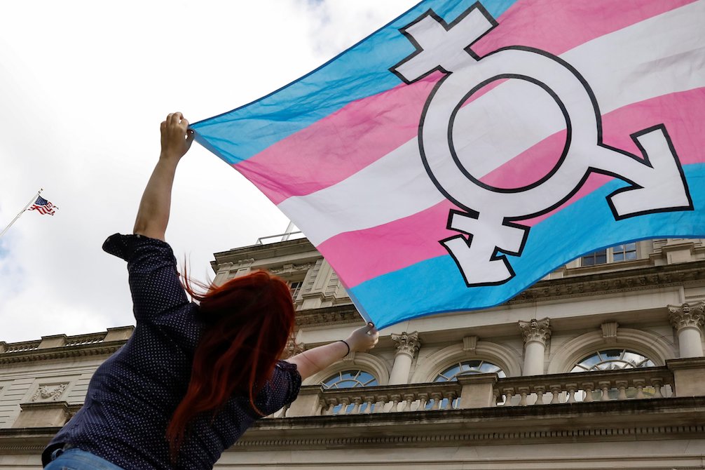 A person in New York City holds up a transgender rights flag Oct. 24, 2018. (CNS/Reuters/Brendan McDermid)